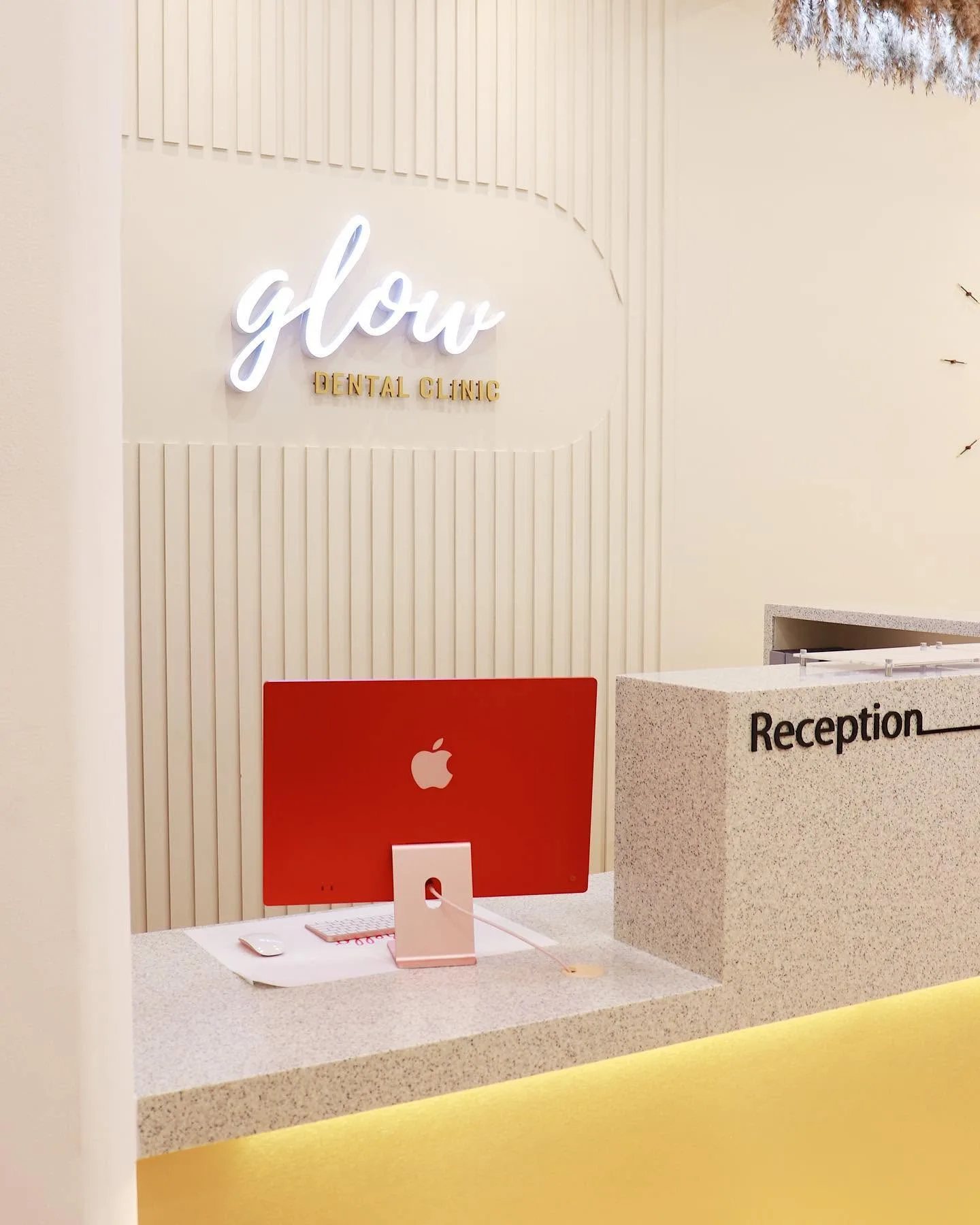 Glow Dental reception desk with Our Story signage