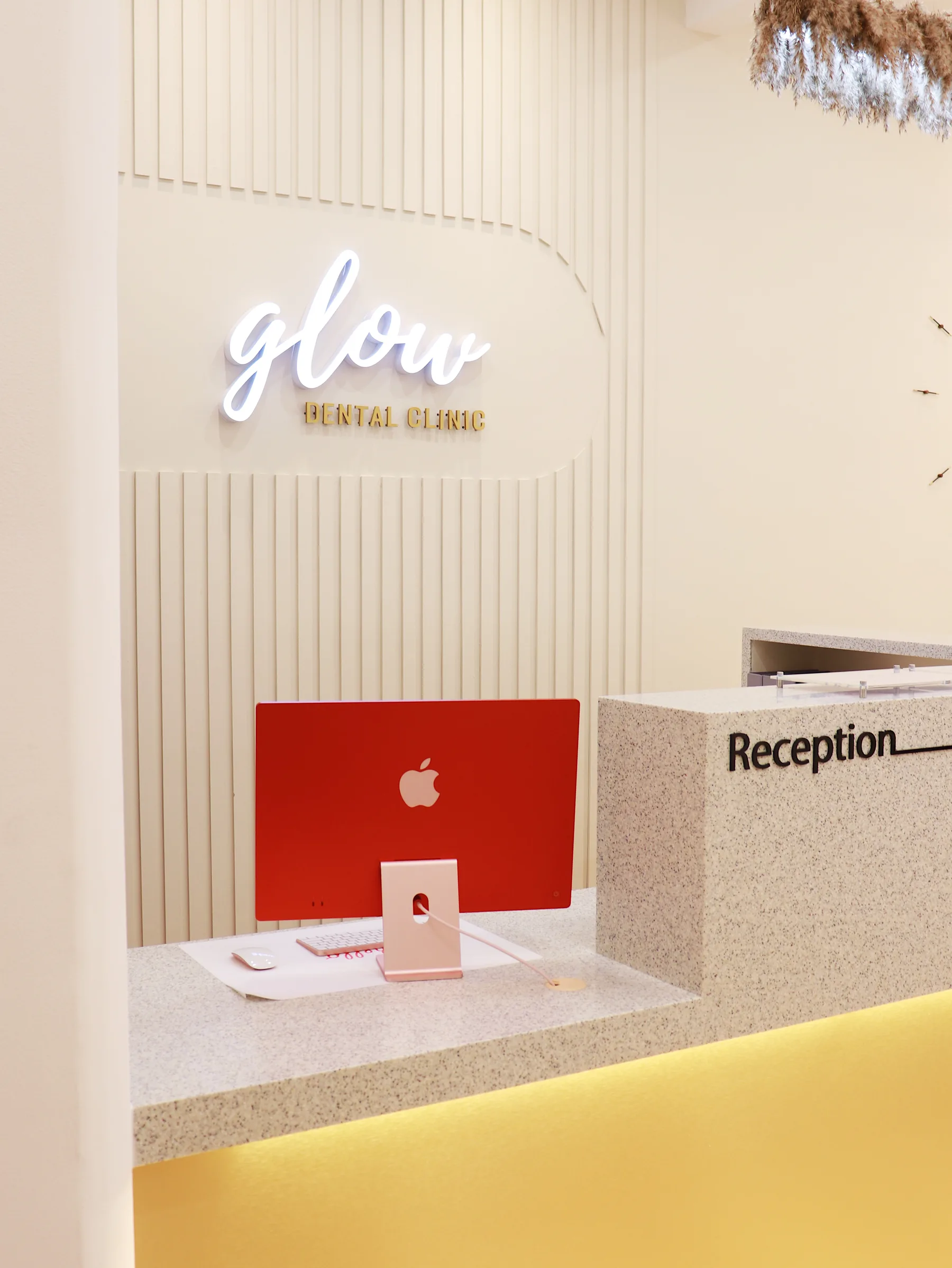 Glow Dental reception with illuminated sign